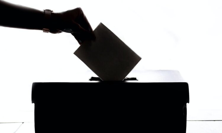 person dropping paper on box